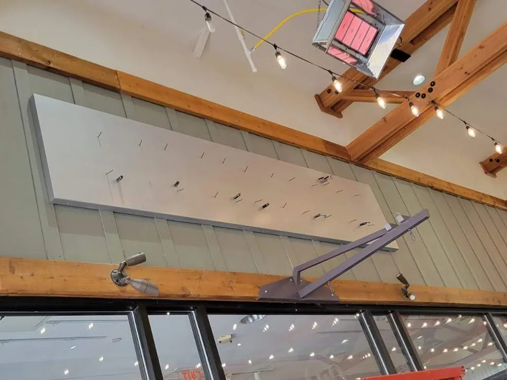Interior retail sign installation in progress at a Chico's store